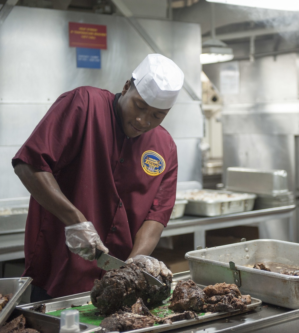 USS Harry S. Truman Sailor prepares roast beef