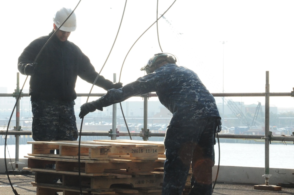 VFA-37 Sailors secure palettes aboard USS George H.W. Bush