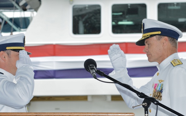 Rear Adm. Jake Korn salutes CGC William Trump commanding officer