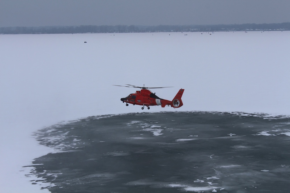 Coast Guard helicopter takes off from frozen lake