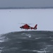 Coast Guard helicopter takes off from frozen lake