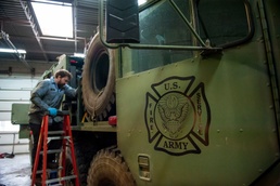 Opening the hose on Army fire truck maintenance