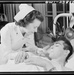 WWII Army nurse helps Soldier in body cast drink juice
