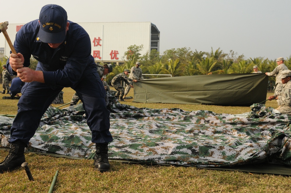 Coast guardsmen and USARPAC Soldiers work with PLA