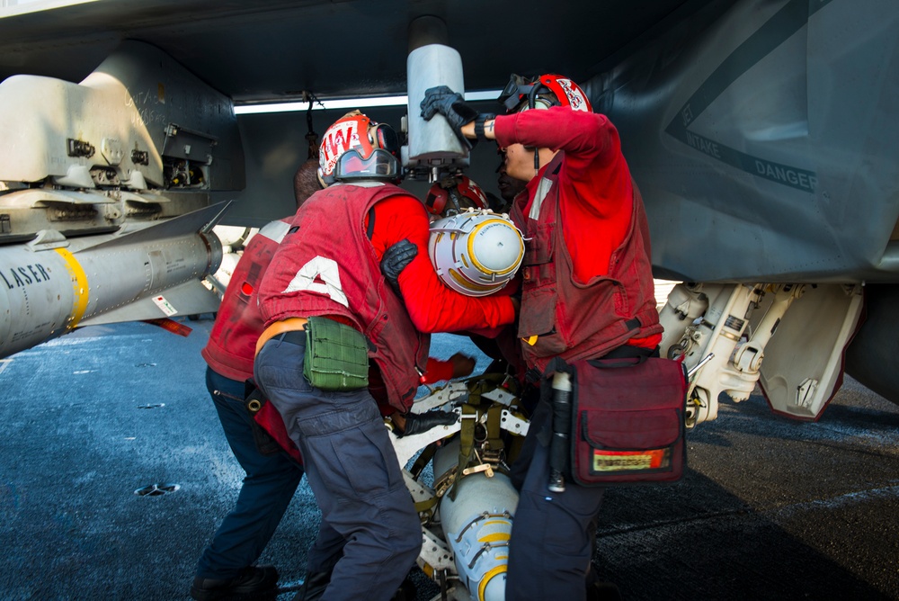 USS Carl Vinson Sailors load ordnance