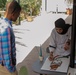 Soldier receives art tips from Kuwaiti student
