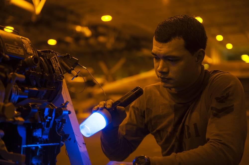 Sailors conduct aircraft maintenance aboard USS Carl Vinson