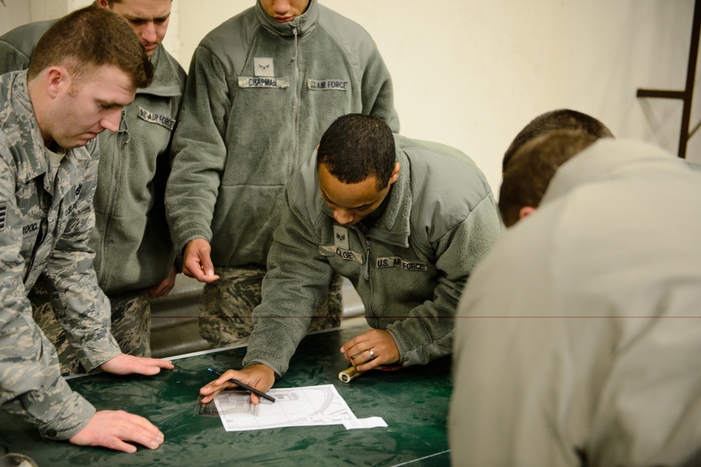 Airmen lay out map for fellow engineers