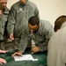 Airmen lay out map for fellow engineers