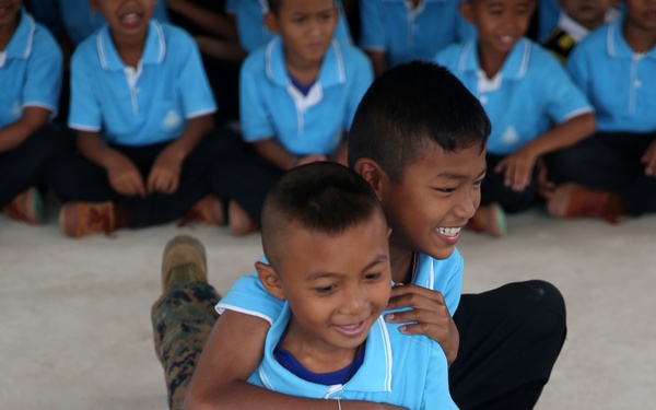 Service members, laugh, play, learn with Thai children during Cobra Gold 15