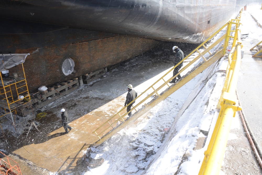 Coast Guard marine inspectors walk through moored vessels in Toledo