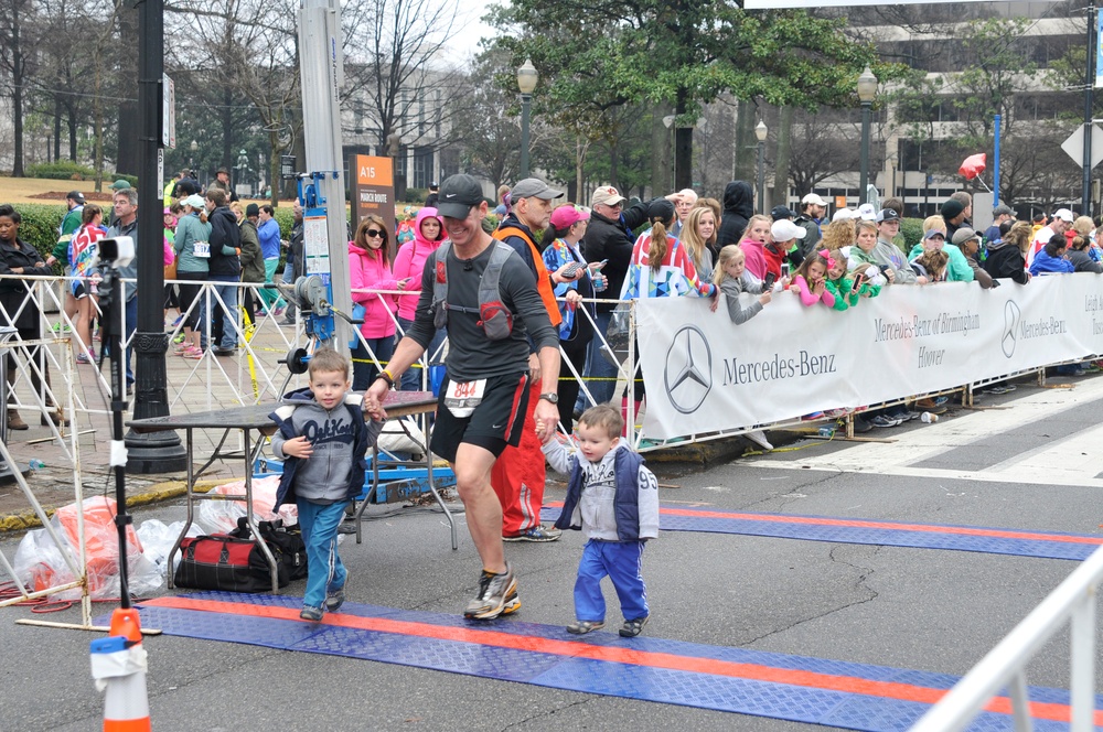 Dad and kids crossing the finish line