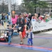Dad and kids crossing the finish line