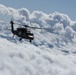 Black Hawk soars over clouds