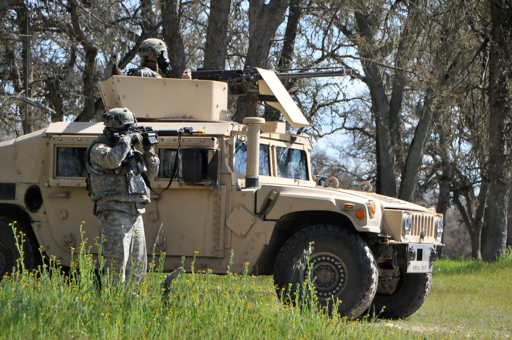 Soldiers of the 571st Military Police Company conduct perimeter defense during a simulated attack with chemical weapons on Base Camp Schoonover