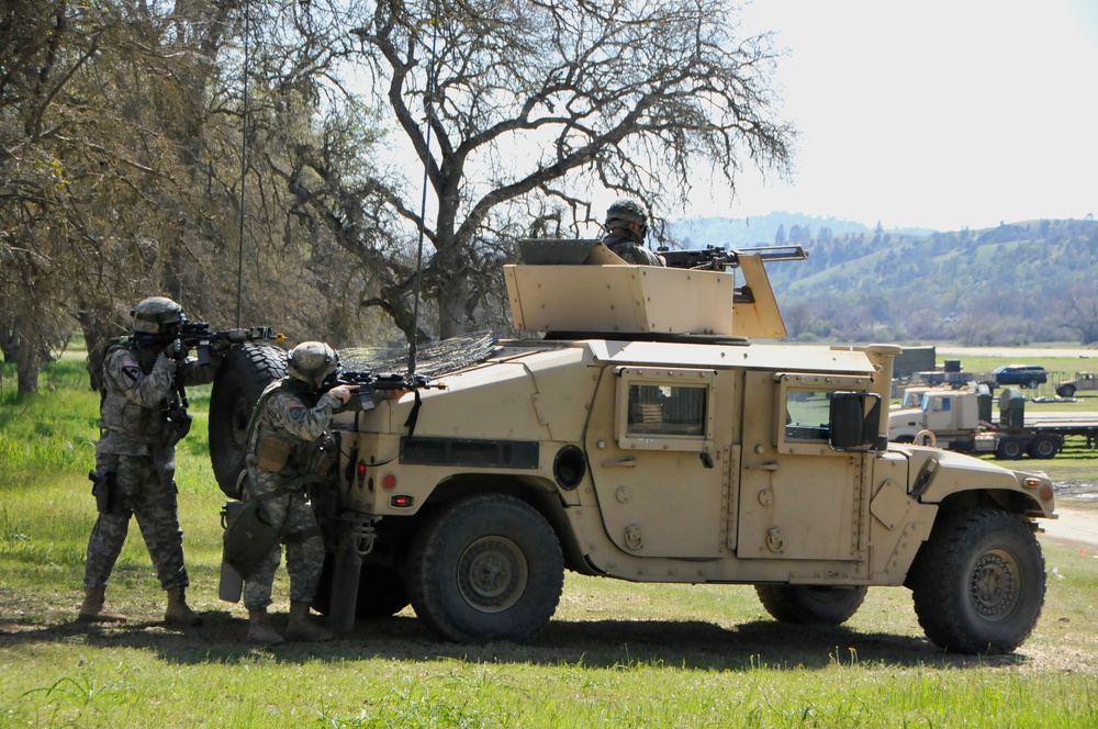 Soldiers with the 571st Military Police Company conduct a perimeter defense during a simulated attack with chemical weapons on Base Camp Schoonover