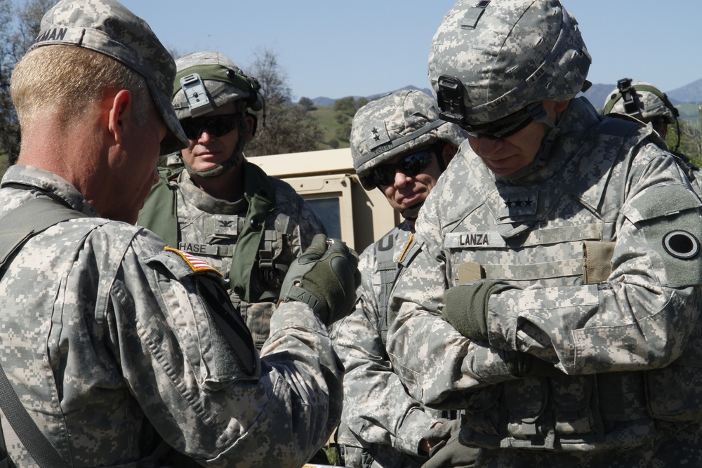 Lt. Gen. Stephen R. Lanza of the I Corps and Maj. Gen. James V. Young of the 75th Training Command listen to a brief from Col. Randall Wickman of the 189th Infantry Brigade