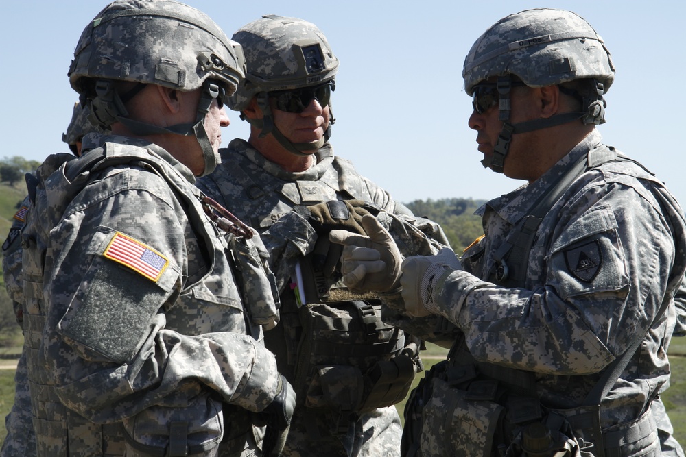 Brig. Gen. John D. Lee of the 91st Training talks to Maj. Gen. Lawrence A. Haskins of the 40th and Col. Jeffery D. Smiley of the 75th Infantry Brigade Combat team about the Combat Support Training Exercise (CSTX)