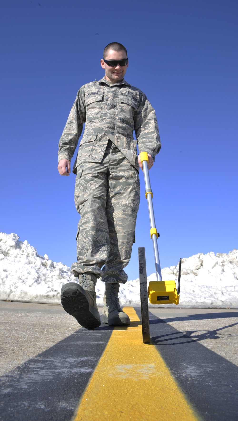 Airman Measures distance between snow and flightline