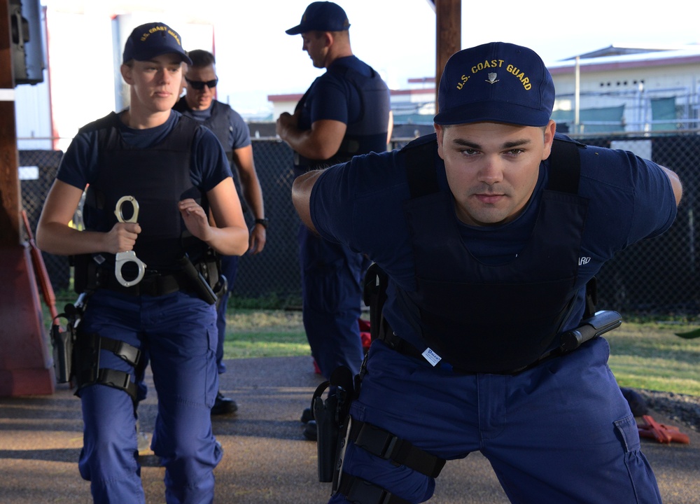 Crewmembers practice handcuffing techniques during law enforcement training