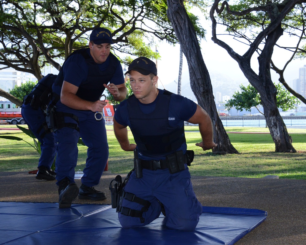 Crewmembers practice handcuffing techniques during law enforcement training