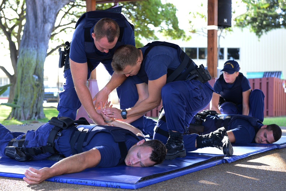 Crew members practice handcuffing techniques during law enforcement training