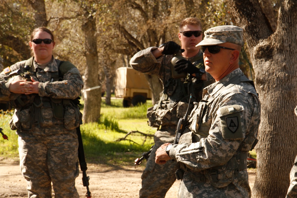 US Army Master Sgt. Matt Gould of the 91st Training Division conducts an after-action review with soldiers from the 209th Quartermaster Company