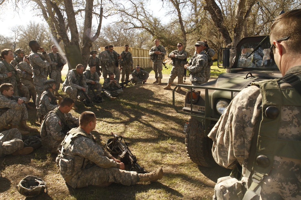 US Army Master Sgt. Matt Gould of the 91st Training Division conducts an after-action review with soldiers from the 209th Quartermaster Company