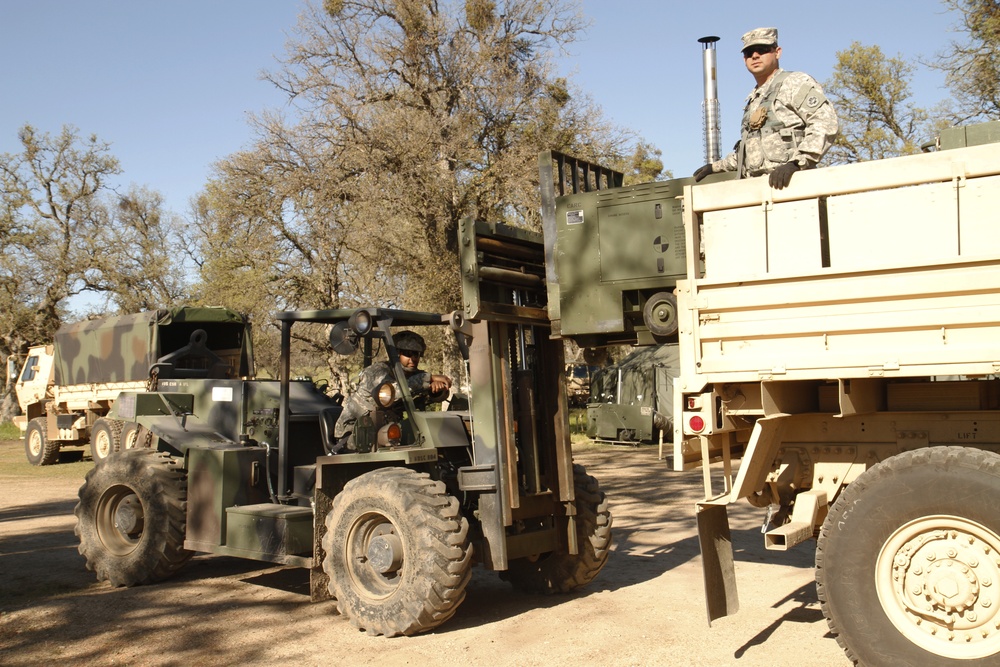 US Army Sgt. Christopher Lamarche and Staff Sgt. Rafael Vou of the 147th Medical Detachment load heaters on Base Camp Schoonover