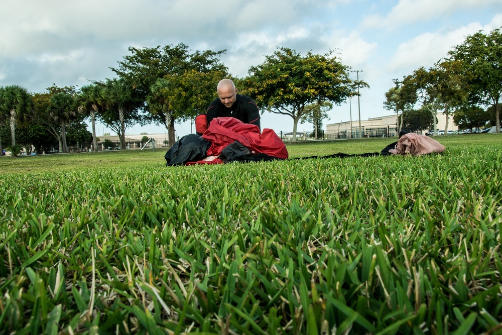 Soldier packs parachute for pre-season training