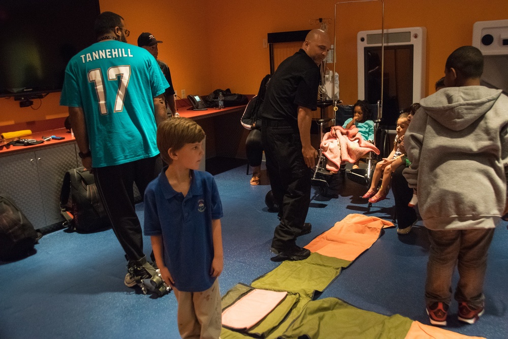Soldiers demonstrate parachuting techniques to hospital patients