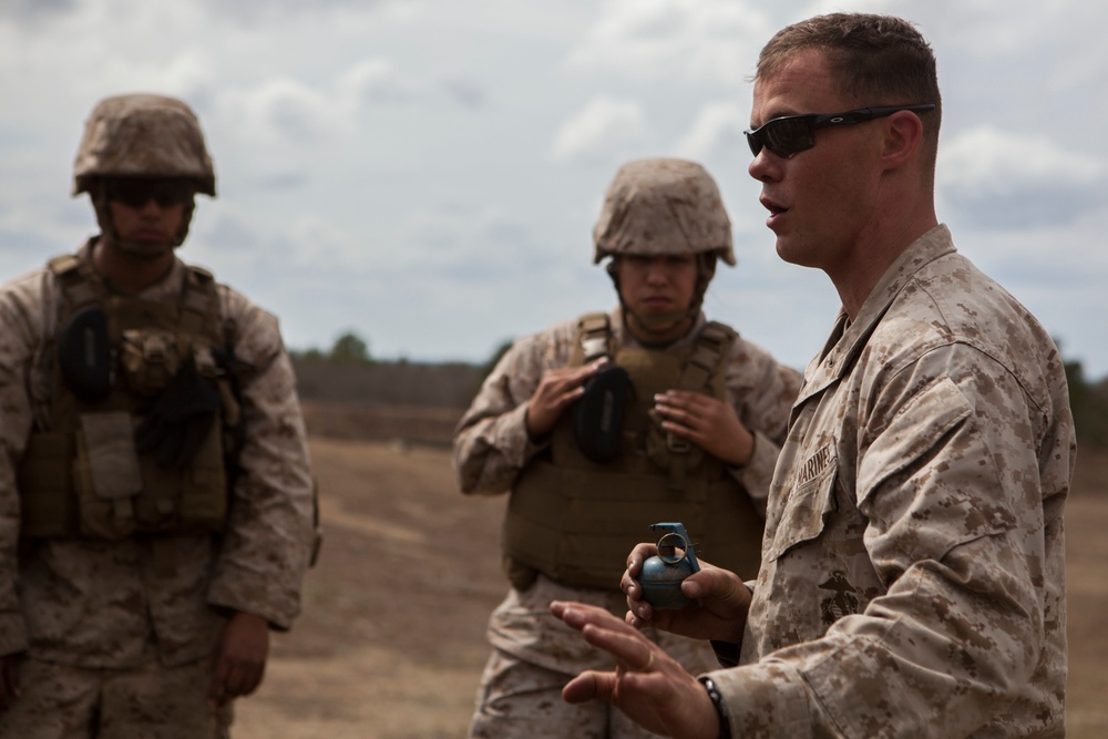 2D Transportation Support Battalion Marines practice throwing hand grenades with Headquarters Battery