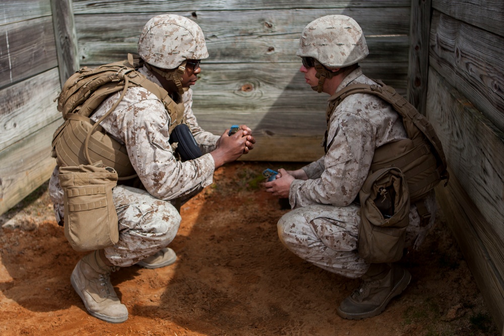 2D Transportation Support Battalion Marines practice throwing hand grenades with Headquarters Battery