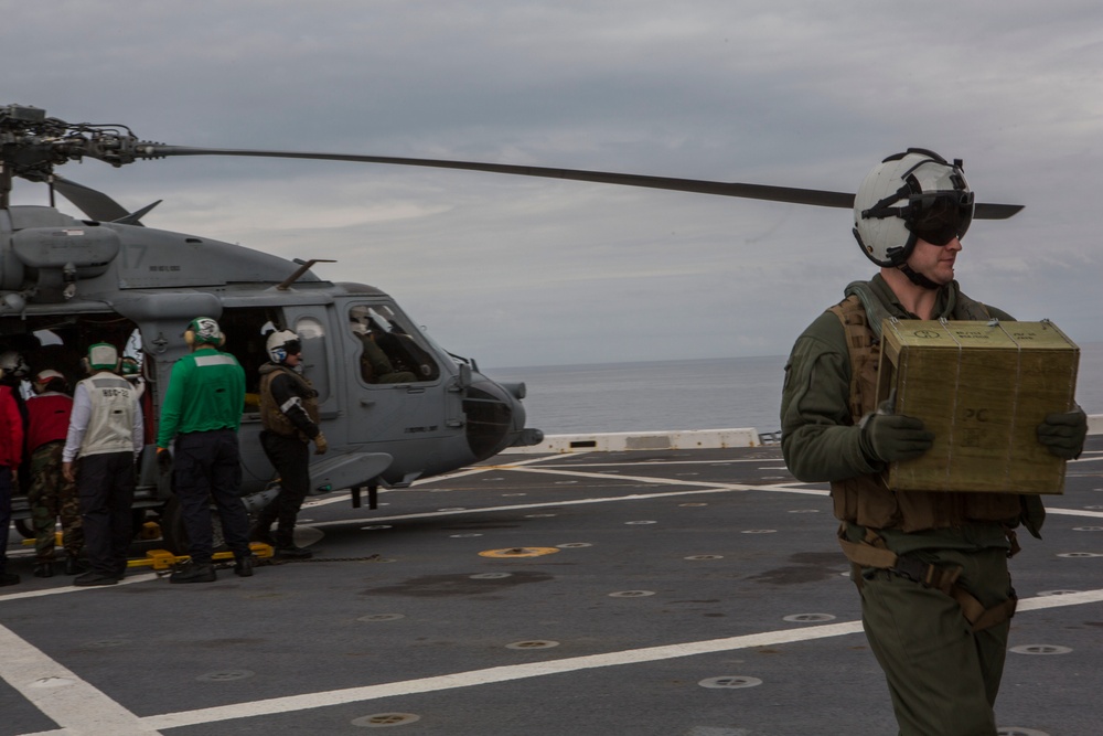 US Navy sailors with USS Arlington conduct maintenance on CH-60