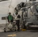 US Navy sailors with USS Arlington conduct maintenance on CH-60