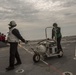 US Navy sailors with USS Arlington conduct maintenance on CH-60
