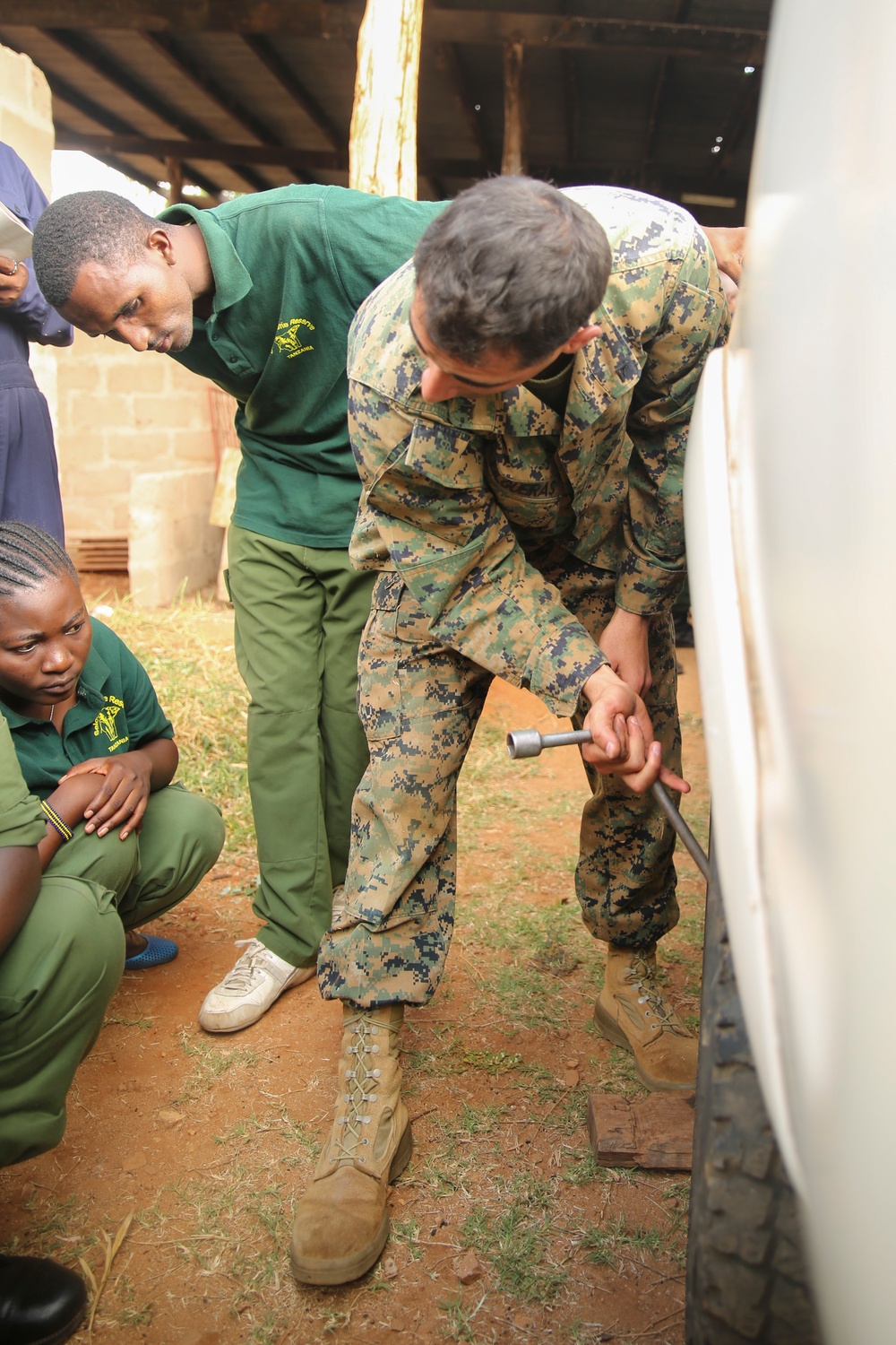 US Marines demonstrate vehicle maintenance to Tanzanian Park Rangers