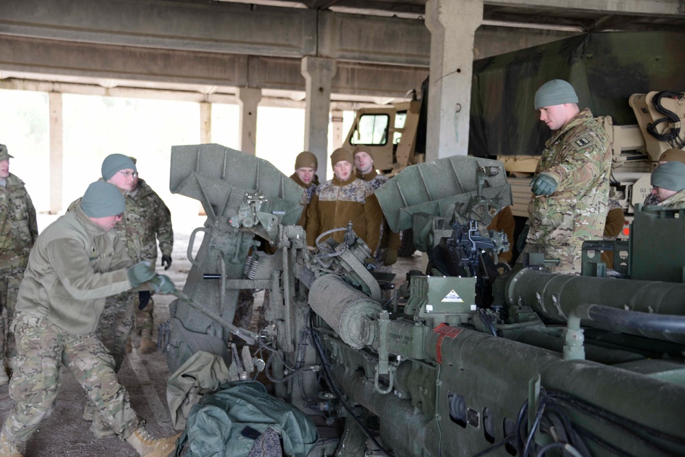 Michigan National Guard Red Lions conduct howitzer maintenance checks with Latvian Land Forces