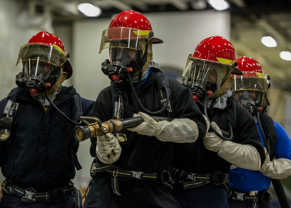 Sailors fight a simulated fire during a general quarters drill