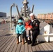 Sailor poses for photo aboard battleship USS Wisconsin