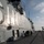 Osprey makes first ever landing on Republic of Korea amphibious assault ship The image shows the flight deck of what appears to be a South Korean naval vessel, identifiable by Korean Hangul text ('소화전' meaning 'fire hydrant') on a door and the hull number '6' visible on the island superstructure. Personnel are gathered near the island structure while a V-22 Osprey tiltrotor aircraft is parked on the deck in the background. The scene suggests a joint military exercise or cooperative naval operation.