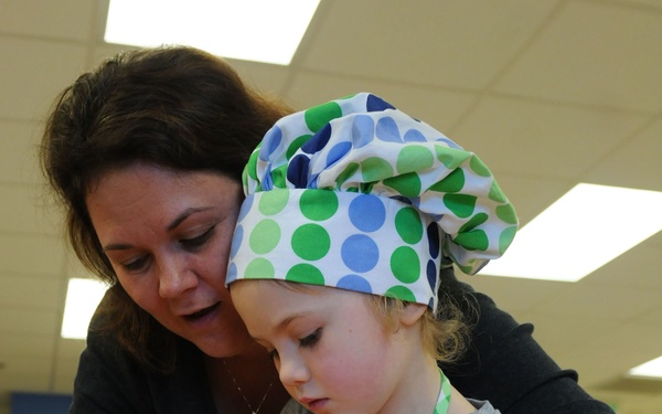 Parents and their kids cook healthy and tasty meals