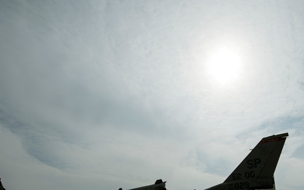 Airmen refuel F-16's during a hot pit refuel