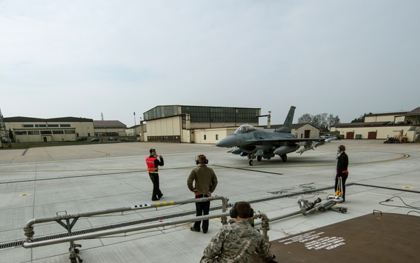 Airmen refuel F-16's during a hot pit refuel