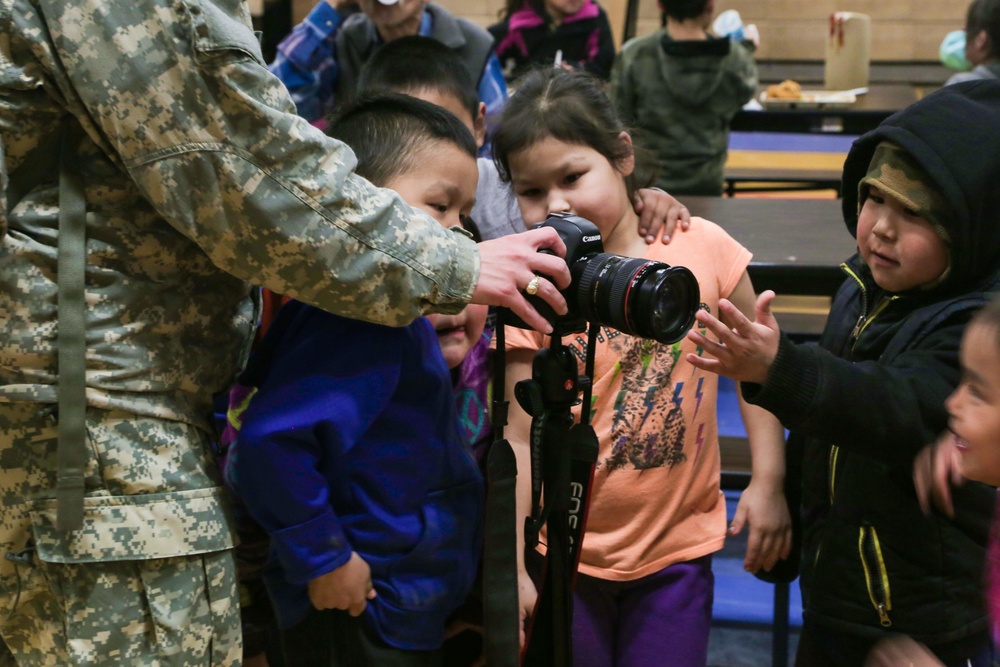 Alaska Army National Guard Soldiers visit with Napaskiak students during annual training