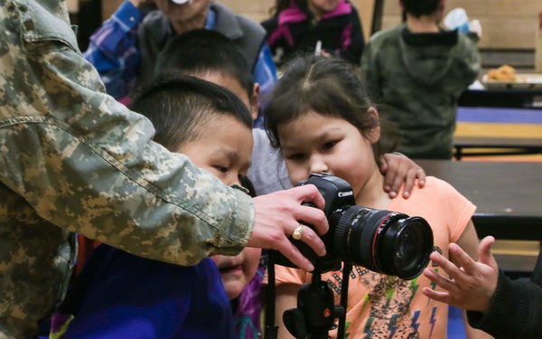 Alaska Army National Guard Soldiers visit with Napaskiak students during annual training