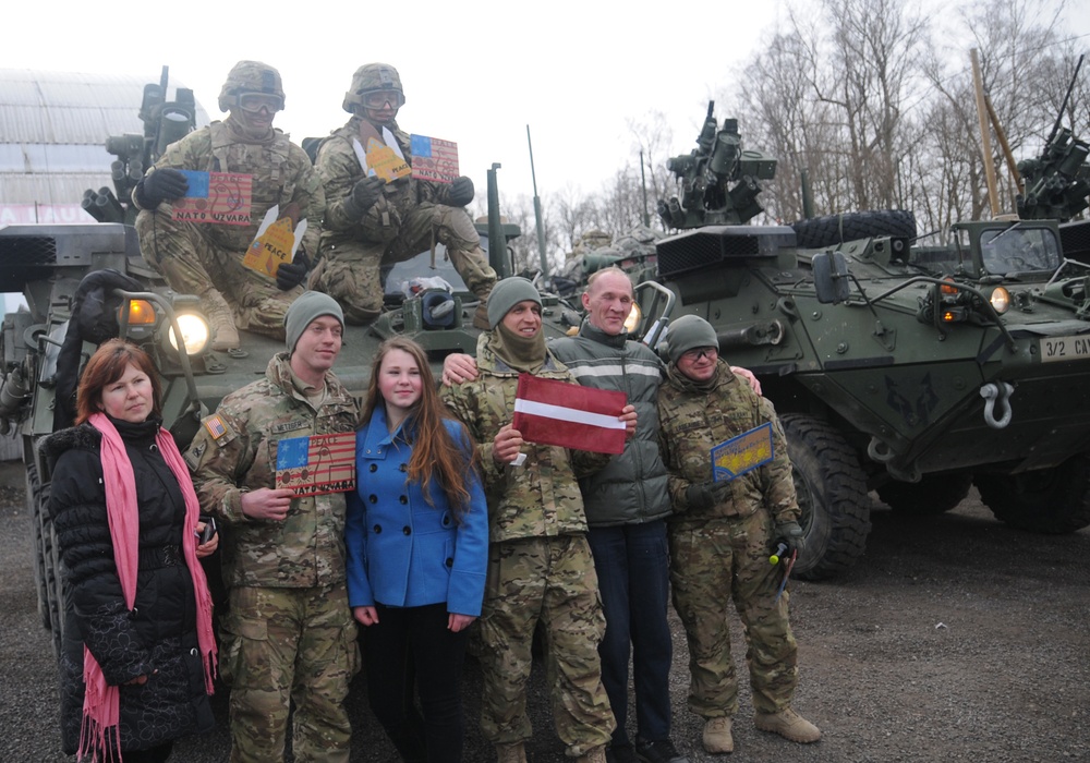 US troops with Latvians and their flag