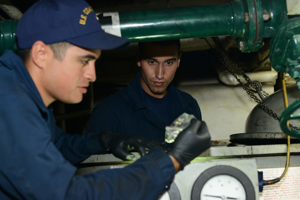 Machinery technicians make repairs to oily water separator