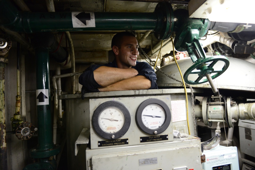 Machinery technicians make repairs to oily water separator