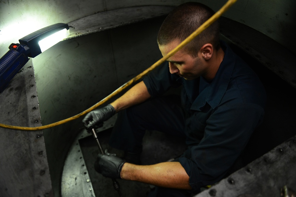 Machinery technician repairs oily water separator